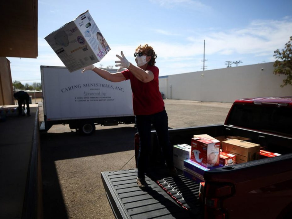 Photo of person loading diapers into a truck