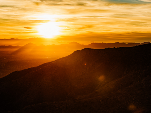 Golden sunset lighting hitting mountain peaks in Tucson