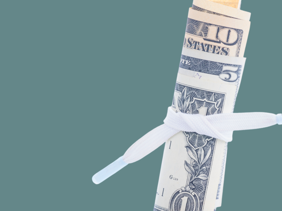 Green background with a roll of money in the front, tied with a shoestring around it