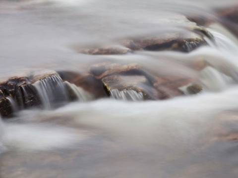 Water flowing down over rocks in a river
