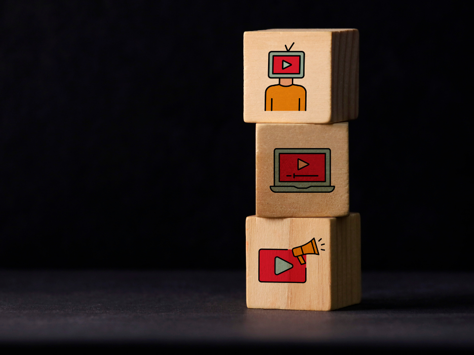 Wooden blocks with different social media video graphics on it
