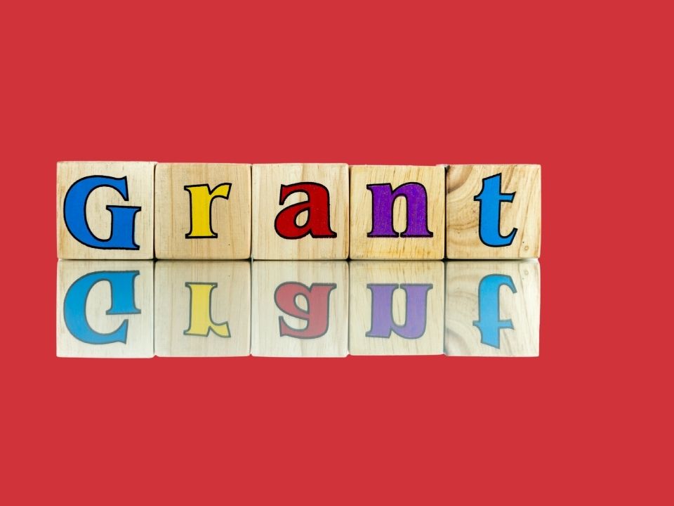 Grant written on wooden blocks in colorful letters.