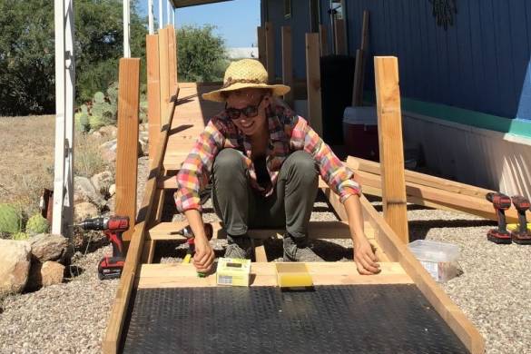Person building a ramp out of wood.