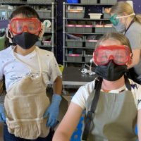 Boys and Girls Club of Bisbee children wearing goggles and aprons.