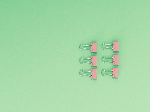 Six pink binder clips