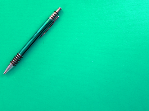 green pen in front of a green background