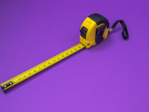 measuring tape in front of a purple background