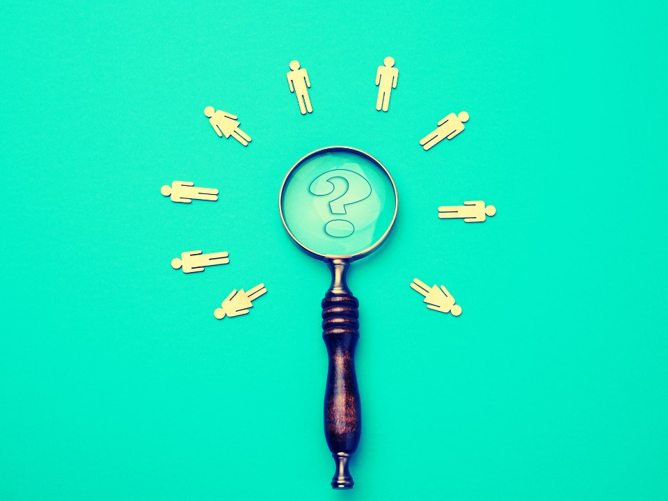 A microscope with a question mark on it with stick figures surronding it