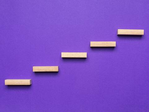 A purple background with 5 blocks lining up like stairs.