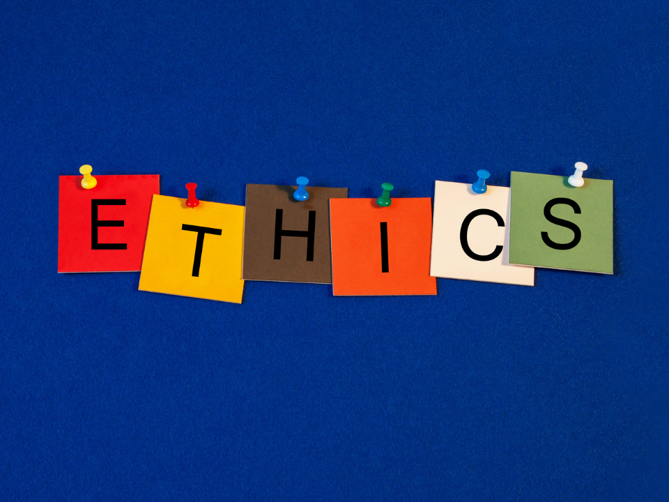 Ethics spelled out on colorful post it notes on a dark blue background